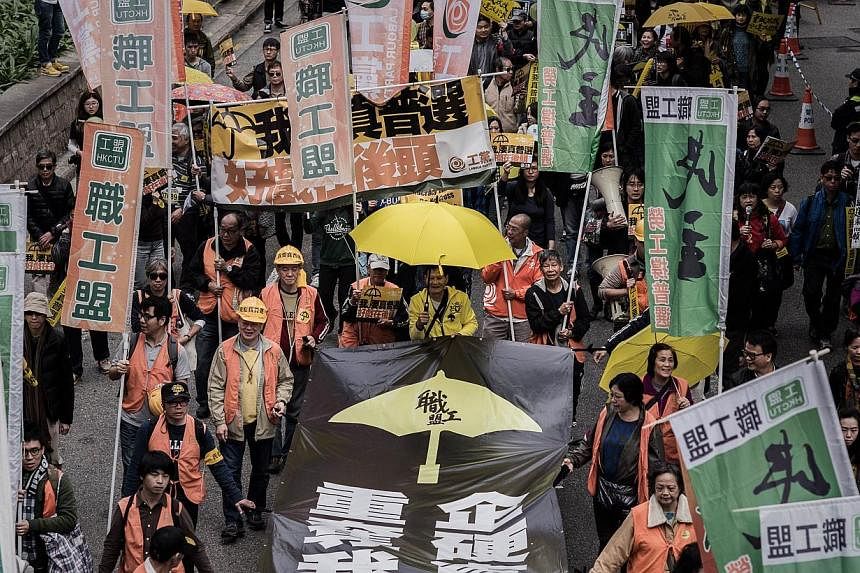 Demonstrators march for democracy in Hong Kong on Feb 1, 2015. A disappointing turnout at Hong Kong's first democracy rally since the end of mass street demonstrations shows the city is suffering from "protest fatigue" and new longer-term strategies 