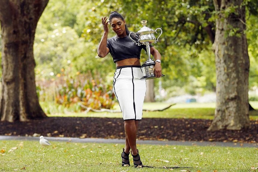 Serena Williams of the US poses with the Daphne Akhurst Memorial Cup after winning the women's singles final match at the 2015 Australian Open tennis tournament during a photo call at Melbourne's Royal Exhibition Building on Feb 1, 2015.&nbsp;Trees i