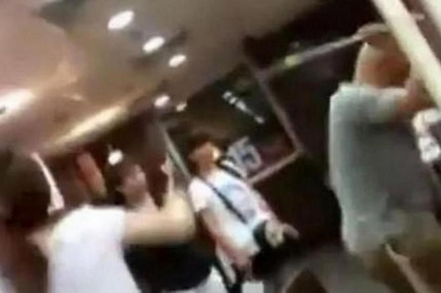 A woman being attacked in front of onlookers at a McDonald's outlet in China's eastern province of Shandong. She was attacked to death by six people who are members of the Church of Almighty God (Quannengshen) religious movement, for refusing to give