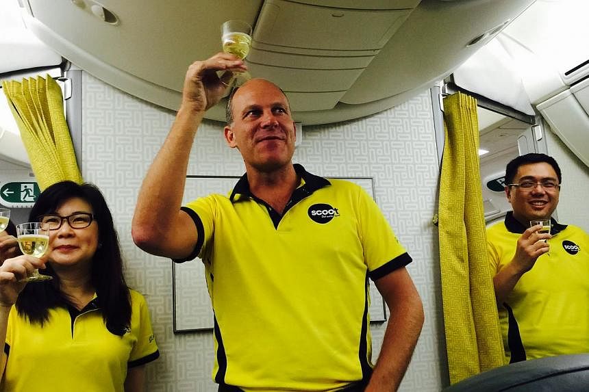 Scoot chief executive officer Campbell Wilson (centre) making a mid-air toast on board the budget airline's first Boeing 787 during the delivery flight from Seattle to Singapore. --&nbsp;ST PHOTO: JERMYN CHOW