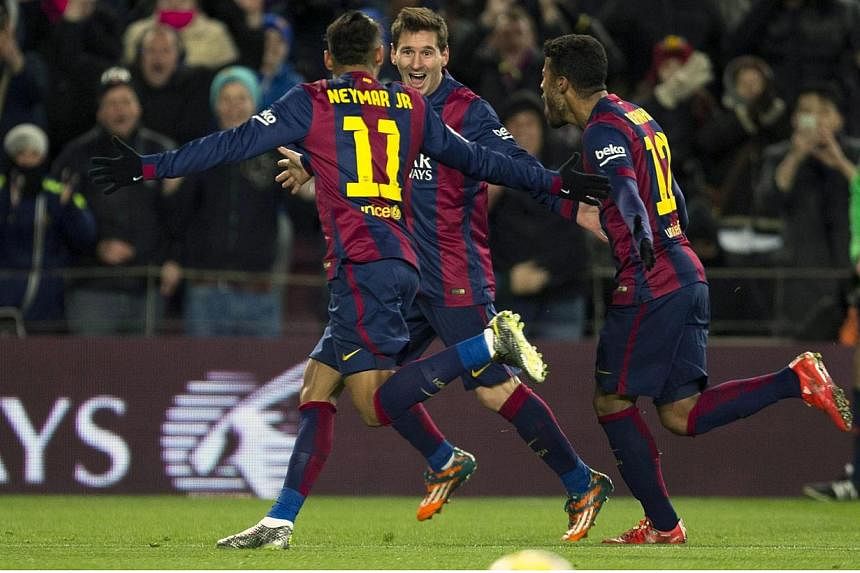 FC Barcelona's Lionel Messi (centre) celebrates with Neymar (left) and Rafinha (right) after scoring the 3-2 leading against Villarreal during the Spanish Primera Division soccer match between FC Barcelona and Villarreal CF at Camp Nou in Barcelona, 