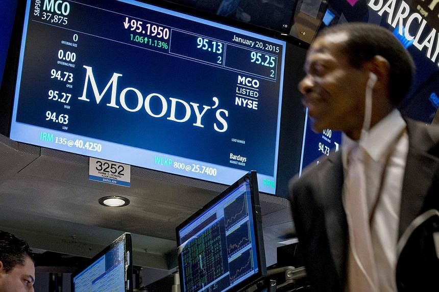 A screen displays Moody's ticker information as traders work on the floor of the New York Stock Exchange on Jan 20, 2015. US authorities are investigating the credit rating agency over its glowing assessments of mortgage deals in the runup to the 200