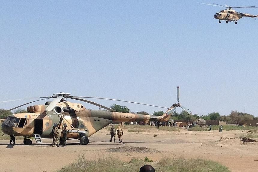 Mi-24 attack helicopters are seen in Fotokol, Cameroon, on Sunday, after an operation in nearby Gamboru, Nigeria. Chadian aircraft struck Boko Haram positions in the Nigerian border town of Gamboru for a second straight day, an AFP journalist in a ne