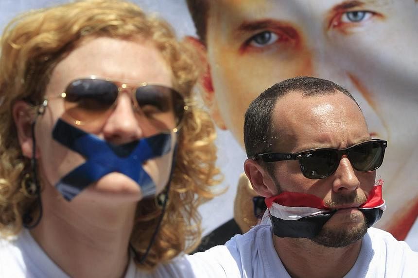 Nairobi-based foreign correspondents sitting in front of Egyptian embassy in Nairobi to protest against imprisonment of Al Jazeera journalists Peter Greste and his colleagues in Egypt in a&nbsp;file photograph dated Feb 4 last year.&nbsp;According to