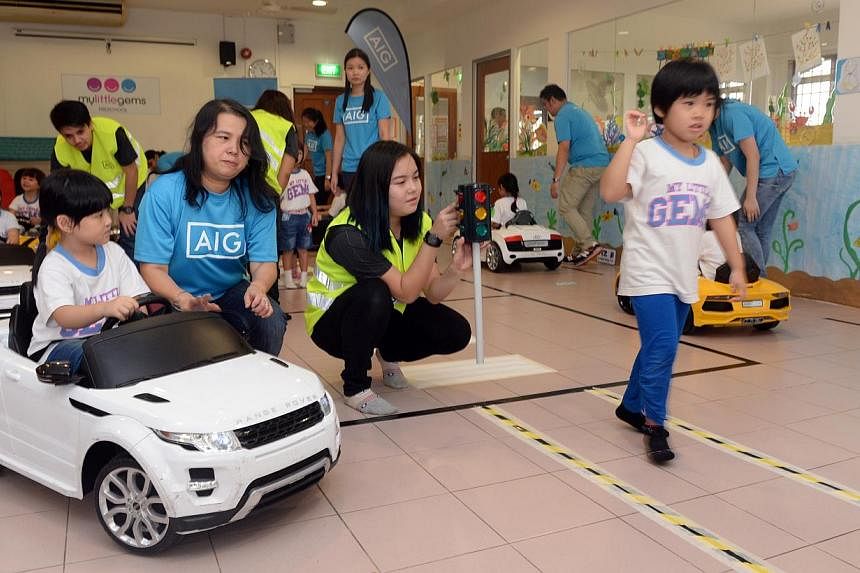 45 pre-school children at My Little Gems Kindergarten took on the roles of motorists and pedestrians in a road safety education programme on Monday. AIG is launching it to teach children between ages 4 to 6 to be safe on roads in Singapore. -- ST PHO