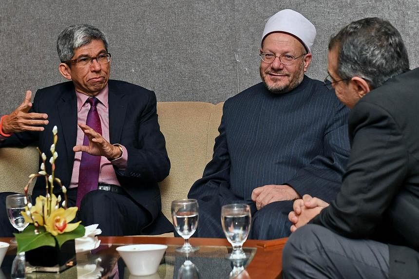 Dr Yaacob Ibrahim (left), Singapore's Minister-in-charge of Muslim Affairs, chatting with Egypt's Grand Mufti Sheikh Shawki Allam (centre) through a translator (right), prior Mr Allam's lecture in Singapore on Jan 26, 2015. Dr Yaacob will lead Singap