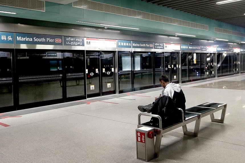 A passenger waiting to board the train at Marina South Pier MRT station on the morning of Feb 3, 2015. -- ST PHOTO: CHEW SENG KIM