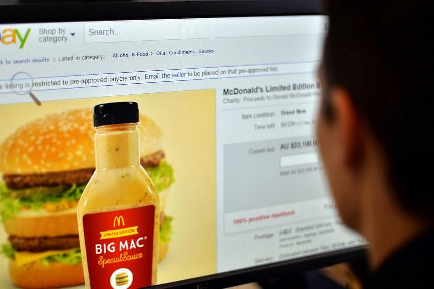 A woman in Sydney looking at a webpage of eBay offering bids for a bottle of fast-food giant McDonald's Big Mac special sauce. -- PHOTO: AFP