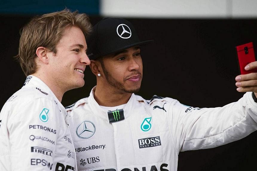 German Formula One driver Nico Rosberg (left) and Briton Lewis Hamilton (right), both from Mercedes, pose for a selfie during the presentation of the new Mercedes W06 Formula One car at Jerez racetrack in Jerez de la Frontera, Spain on Feb 1, 2015.&n