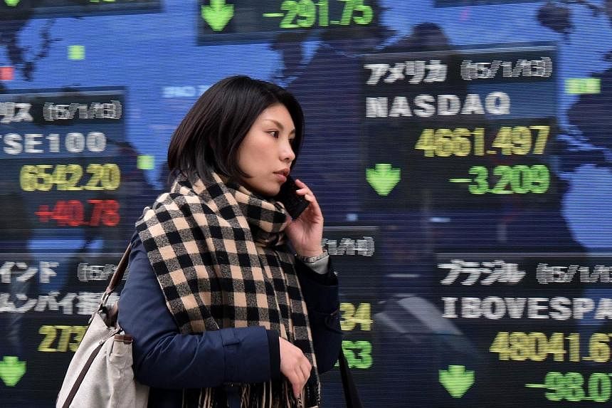 Asian stocks declined, with Japanese exporters sliding as the yen strengthened after the Reserve Bank of Australia (RBA) cut interest rates to a record low. -- PHOTO: AFP