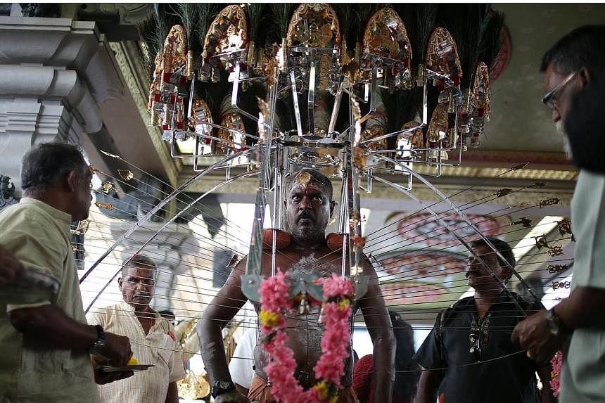 A devotee carrying his kavadi waits to start the procession during Thaipusam festival in Singapore on Feb 3, 2015. Thaipusam is a Hindu festival observed on the day of the full moon during the Tamil calendar month of Thai, and celebrated in honour of