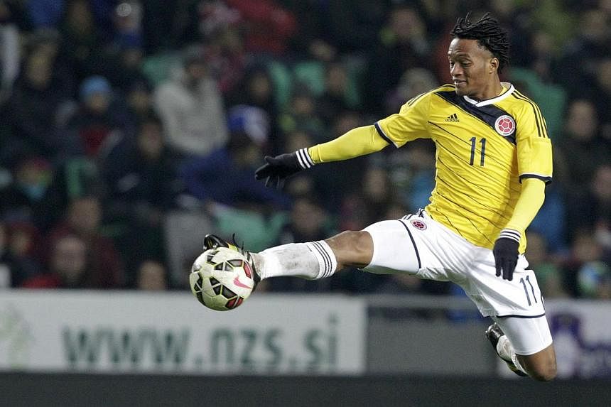 Colombia's Juan Cuadrado jumps to reach the ball during their international friendly soccer match against Slovenia in Ljubljana in November last year. -- PHOTO: REUTERS