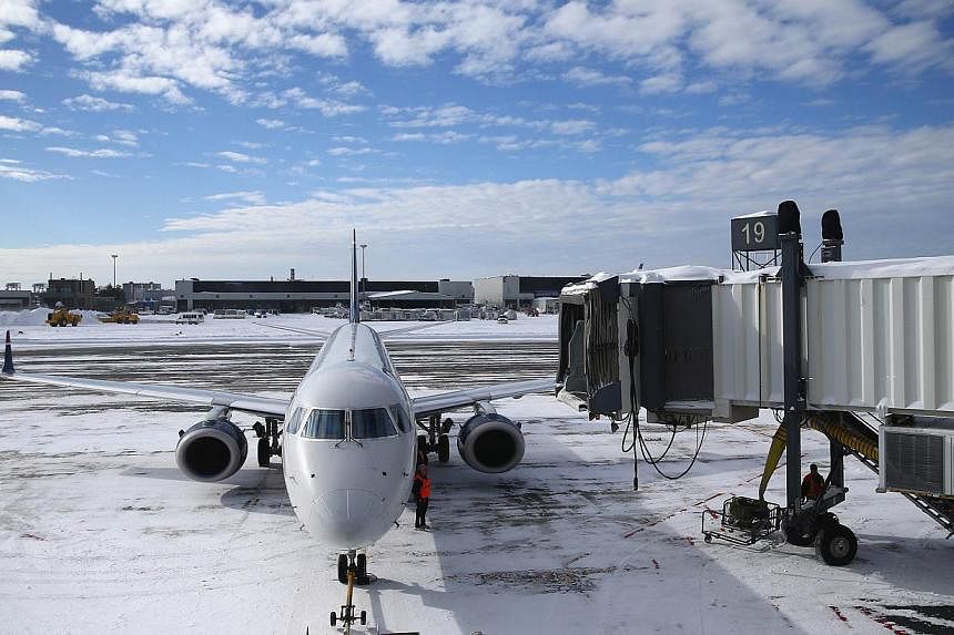 A plane taxis into its gate at Boston's Logan International Airport after the area was hit by Winter Storm Juno last week. Another storm is hitting the US Northeast today that is cancelling flights and causing havoc from Chicago to Cleveland and agai