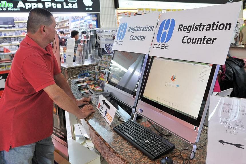A man standing at the Consumers Association of Singapore complaints kiosk at Sim Lim Square. -- PHOTO: ST FILE