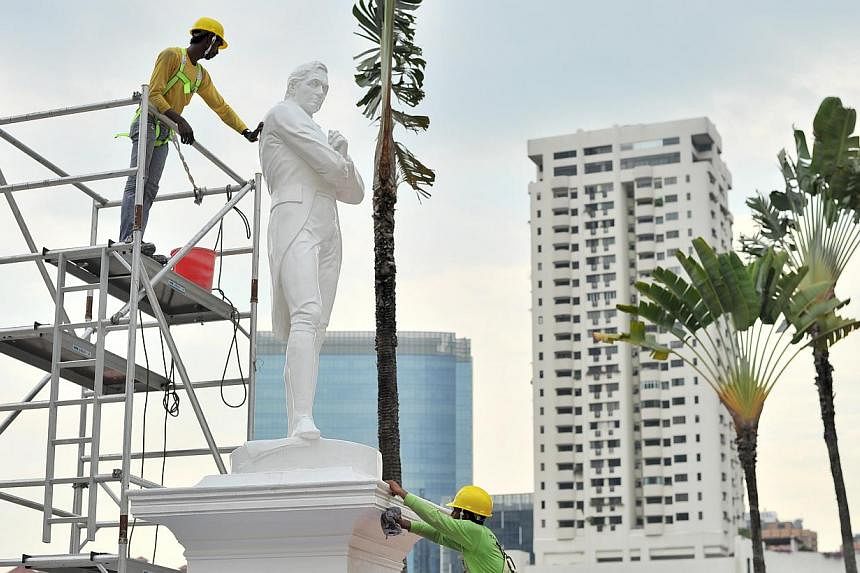 The statue of Sir Stamford Raffles being cleaned in 2014. -- PHOTO: ST FILE