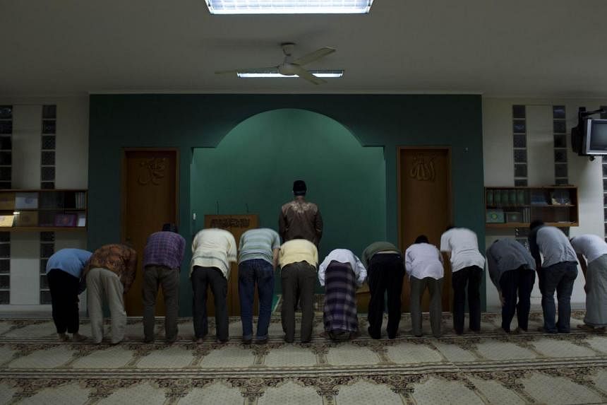 Mr Iskandar Gumay (centre), cleric of Indonesia's minority Ahmadi Muslim community, leads prayers at the al-Hidayah mosque in Jakarta on Jan 21, 2015. Members of the Ahmadi sect, along with other minorities such as Shi'ites and Christians, have faced