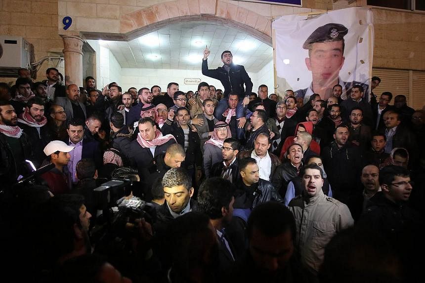 Supporters and family members of Jordanian pilot First Lieutenant Maaz al-Kassasbeh, 26-year-old, gather following his reported killing, at the Karak tribal gathering chamber or Diwan, in the Jordanian capital Amman on Feb 3, 2015. -- PHOTO: AFP