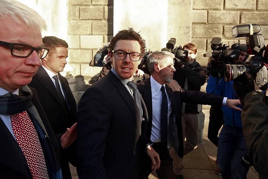 Northern Ireland golfer Rory McIlroy (centre) arrives at the High Court in Dublin Feb 3, 2015. McIlroy and his former agent have settled a multi-million-dollar lawsuit in Dublin, leaving the world's top golfer free to focus on completing the career G