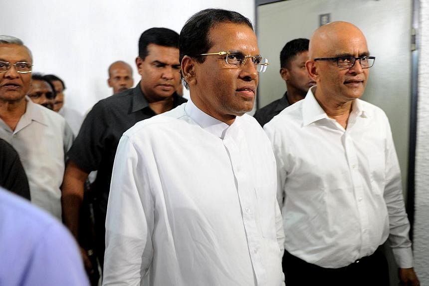 Sri Lanka's President Maithripala Sirisena (centre) emerges from a meeting in Colombo on Jan 16, 2015. Mr Sirisena is to visit New Delhi later this month on what is expected to be his first foreign trip since winning power, India's Prime Minister Nar
