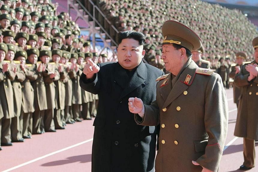North Korean leader Kim Jong Un (centre) gesturing during a photo session at a meeting of military and political cadres in this undated photo released by North Korea's Korean Central News Agency in Pyongyang on Feb 2, 2015. -- PHOTO: REUTERS