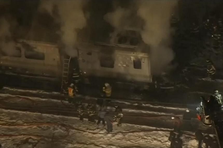 Still images of aerial video showing first responders battling fire on a New York City Metro-North train following an accident near Valhalla, New York on Feb 3, 2015. At least six people died on Tuesday evening when a New York commuter train struck a