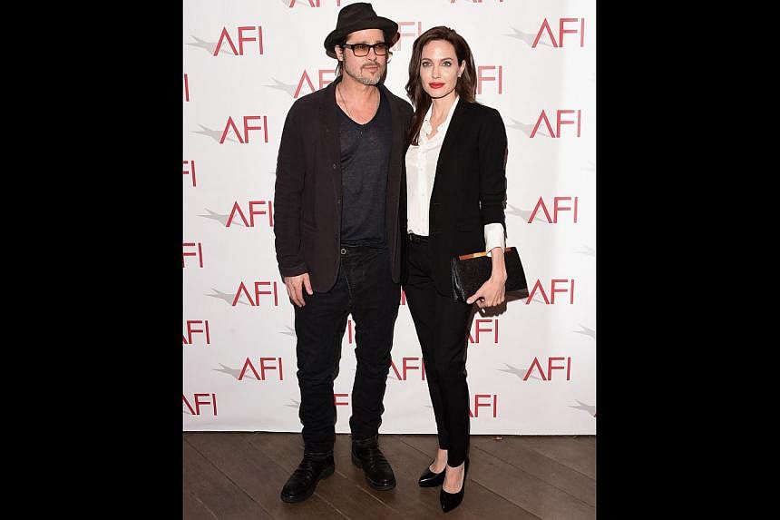 Director Angelina Jolie (above, with husband Brad Pitt) who directed Unbroken, about Olympic athlete Louis Zamperini surviving being adrift at sea and a gruelling experience in a Japanese war camp. -- PHOTO: AGENCE FRANCE-PRESSE