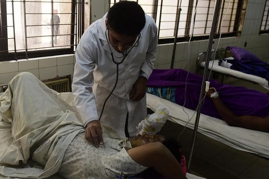 A Bangladeshi resident who suffered burn injuries after a petrol bomb attack on a bus is treated by a doctor at the Dhaka Medical College Hospital in Dhaka on Feb 3, 2015. Bangladesh police on Wednesday, Feb 4, charged opposition leader Khaleda Zia w