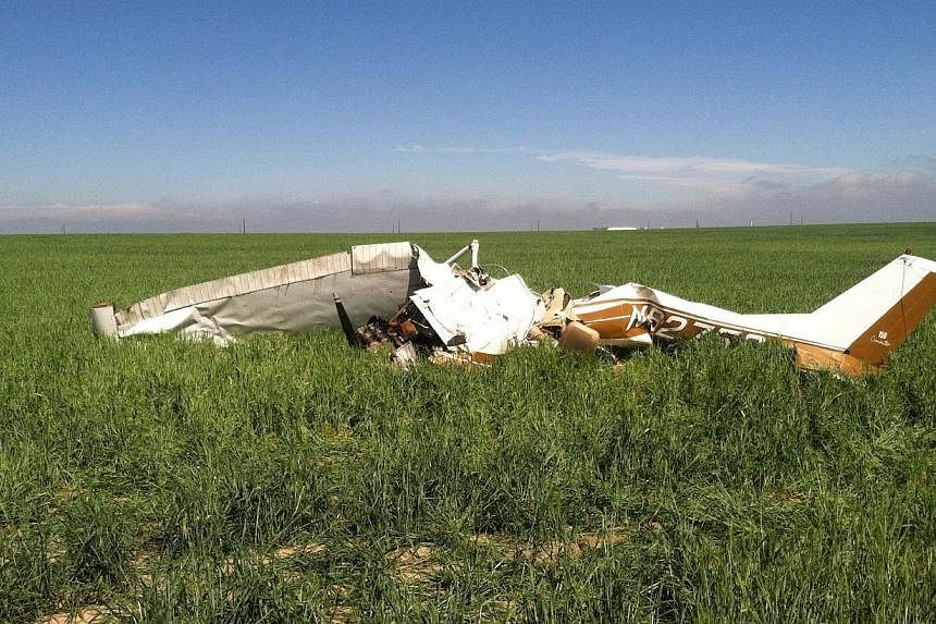 The wreckage of the crashed Cessna 150 airplane lying in a field near Watkins, Colorado on May 31, 2014. The pilot was taking selfie pictures with his phone before he crashed, killing himself and a passenger, investigators found. -- PHOTO: REUTERS