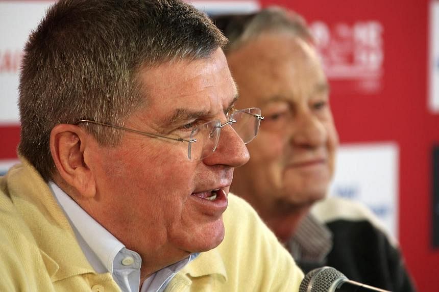 World Cup chiefs have promised the controversial 2022 tournament in Qatar will not clash with that year's Winter Olympics, International Olympic Committee president Thomas Bach (above) said on Tuesday. -- PHOTO: EPA