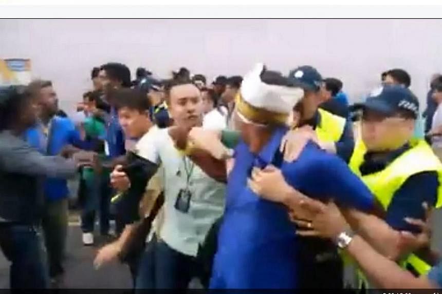 A man is led away by police during the scuffle in a still from a video posted on the Facebook page of Mickey Vikieboy.&nbsp;Three Singaporean men have been arrested for a scuffle with police officers along Desker Road during a Thaipusam procession on