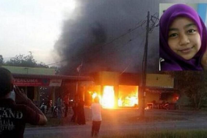 The sundry shop in Jalan Sungai Tiang, Pendang, on fire. Schoolgirl Wan Putri Nur Aisyah Abdullah was inside buying snacks and burnt to death. -- PHOTO: THE STAR/ASIA NEWS NETWORK&nbsp;