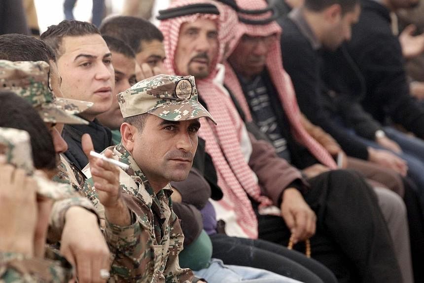 Senior Jordanian army officers and family members gather during a mourning ceremony for Jordanian pilot Maaz al-Kassasbeh at the headquarters of the family's clan in the Jordanian city of Karak on Feb 4, 2015. -- PHOTO: AFP