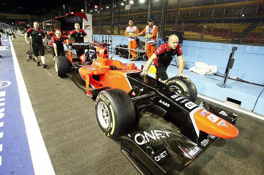 The Marussia F1 team push their car out of the garage, a day before the SingTel Singapore Grand Prix 2012 Formula One practice session, at the F1 pit building on Singapore's Marina Bay Circuit on Sep 20, 2012.&nbsp;The troubled F1 team could start th