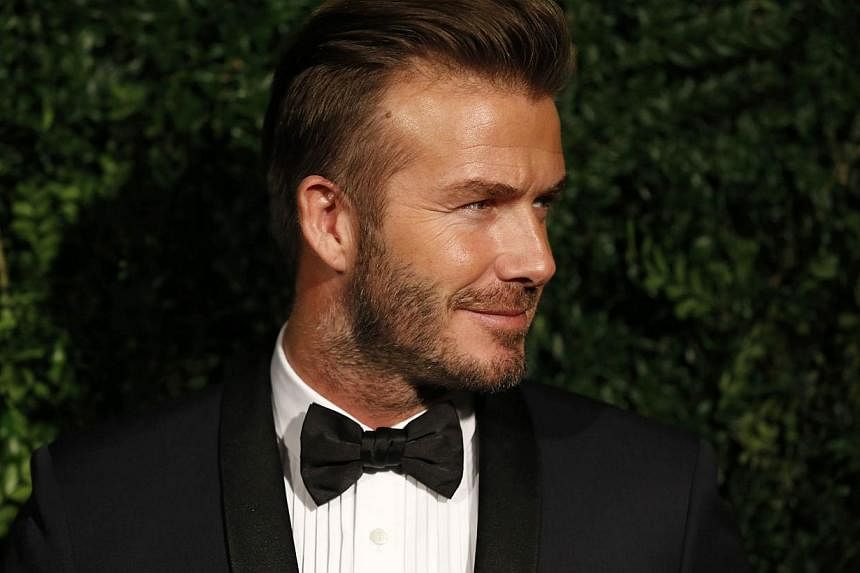 Former England football captain David Beckham poses on the red carpet as he attends the 60th London Evening Standard Theatre Awards 2014 in London in November last year. -- PHOTO: AFP
