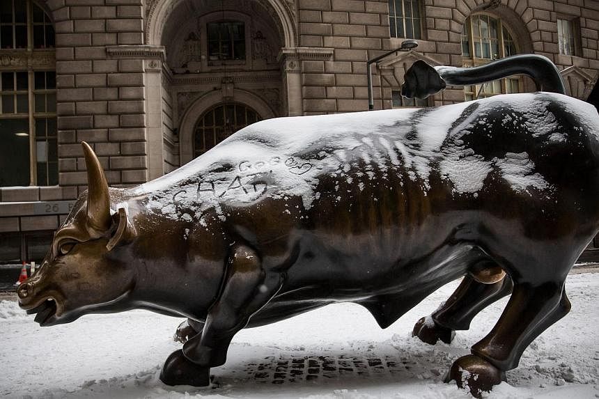 The Wall Street Bull, officially called Charging Bull, is covered in snow after recent snowstorms in New York City. -- PHOTO: AFP&nbsp;