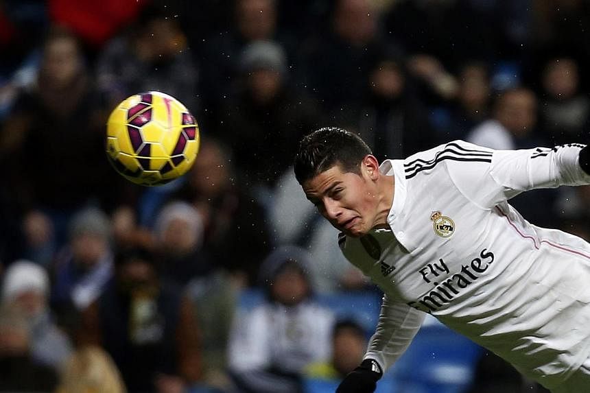 Real Madrid's James Rodriguez scores against Sevilla during their Spanish first division soccer match at Santiago Bernabeu stadium in Madrid on Feb 4, 2015. -- PHOTO: REUTERS