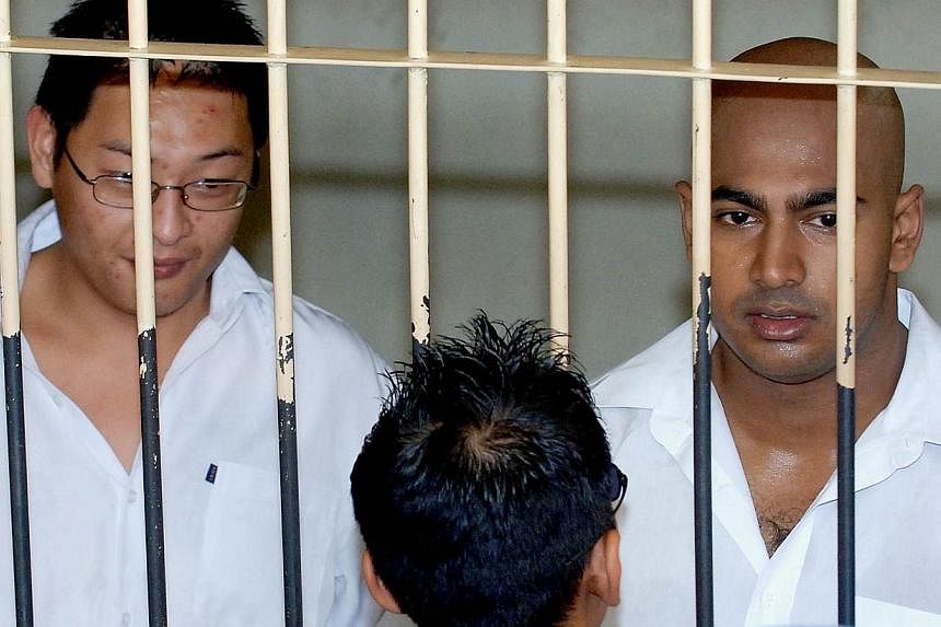In this file photograph taken on Feb 14, 2006, two Australian drug traffickers Andrew Chan (left) and Myuran Sukumaran (right), the ringleaders of the "Bali Nine" drug ring, are seen in a holding cell while awaiting court trial in Denpasar, on Bali i