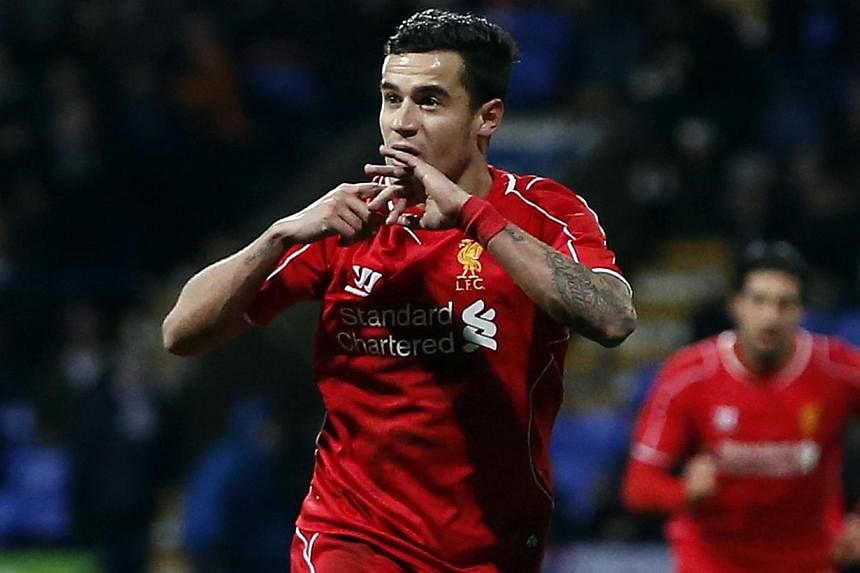 Liverpool's Philippe Coutinho celebrating after scoring his team's second goal during their FA Cup fourth round replay against Bolton Wanderers. -- PHOTO: REUTERS