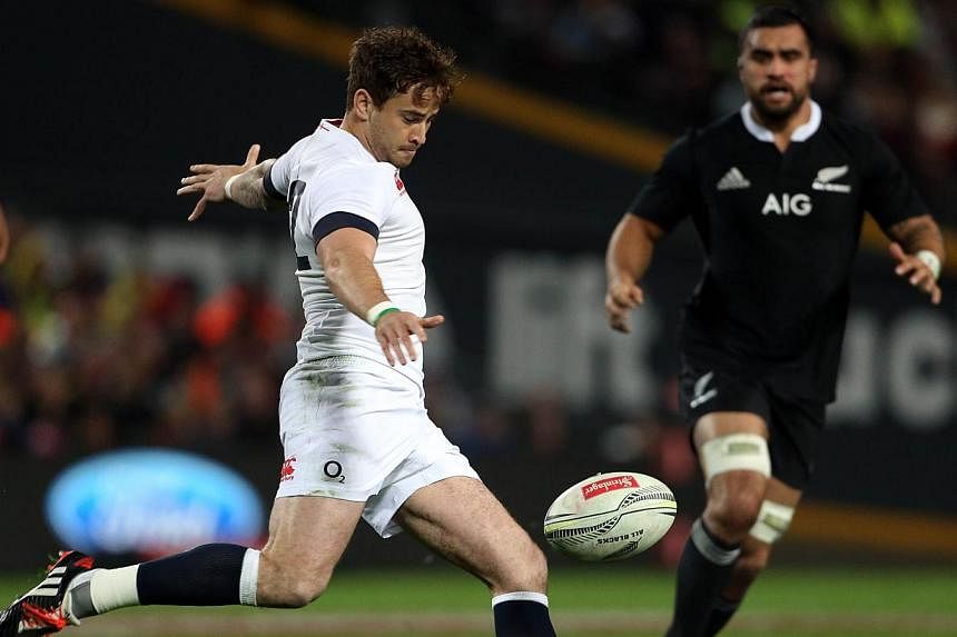 In this file picture taken on June 21, 2014, England's Danny Cipriani clears the ball under pressure from the New Zealand defence during the third rugby union test match in Hamilton. Luther Burrell and Jonathan Joseph will form a new midfield partner