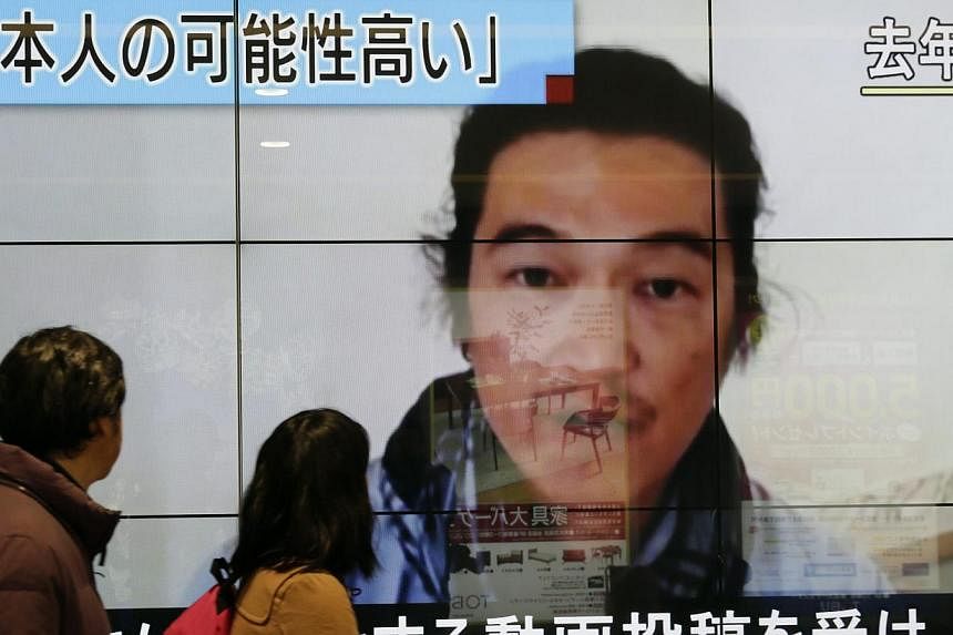 An image of journalist Kenji Goto with news reporting he had been killed by Islamic State in Iraq and Syria (ISIS) militants is seen in Tokyo on Feb 1,&nbsp;2015. A small elite crew of police runners equipped with cameras will take part in the Tokyo 