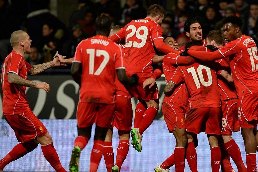 Liverpool's players celebrate after Phillipe Coutinho (10) scored the winning goal during the FA Cup fourth round replay match between Bolton Wanderers and Liverpool in Bolton, Britain on&nbsp;Feb 4,&nbsp;2015. Premier League giants Liverpool on Thur