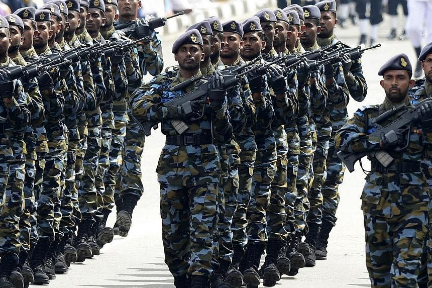 Sri Lankan military personnel march past during the country's 67th Independence Day celebrations in Colombo on Feb 4, 2015. Sri Lanka's new President Maithripala Sirisena has renewed orders allowing for troops to be deployed across the island, dampen