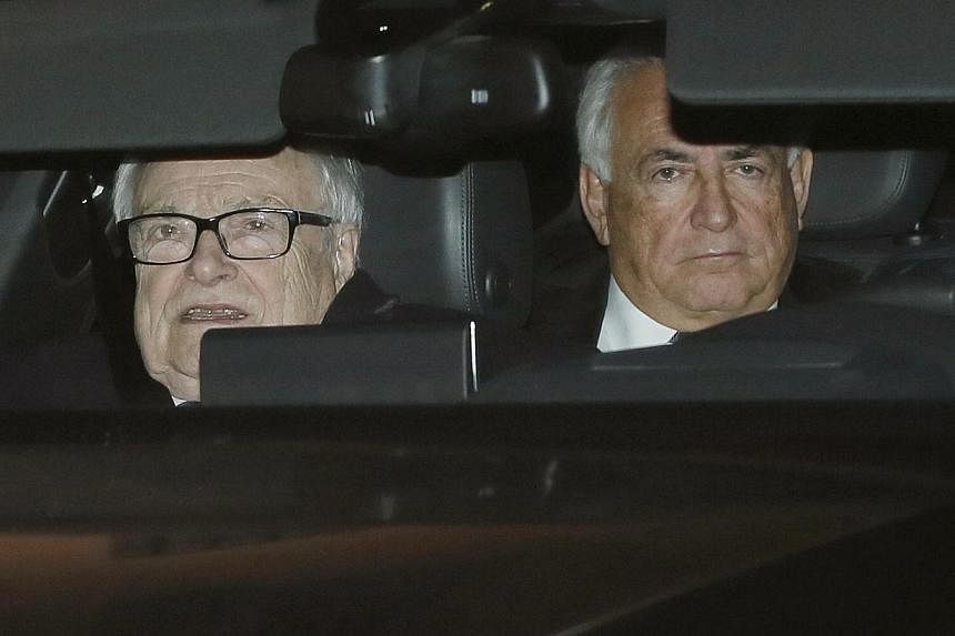 Former IMF head Dominique Strauss-Kahn (right) rides in the backseat of a car as he leaves with Henri Leclerc (left), one of his lawyers, after the first day of trial in the so-called Carlton Affair, in Lille, Feb 2, 2015.&nbsp;Sri Lanka's new govern