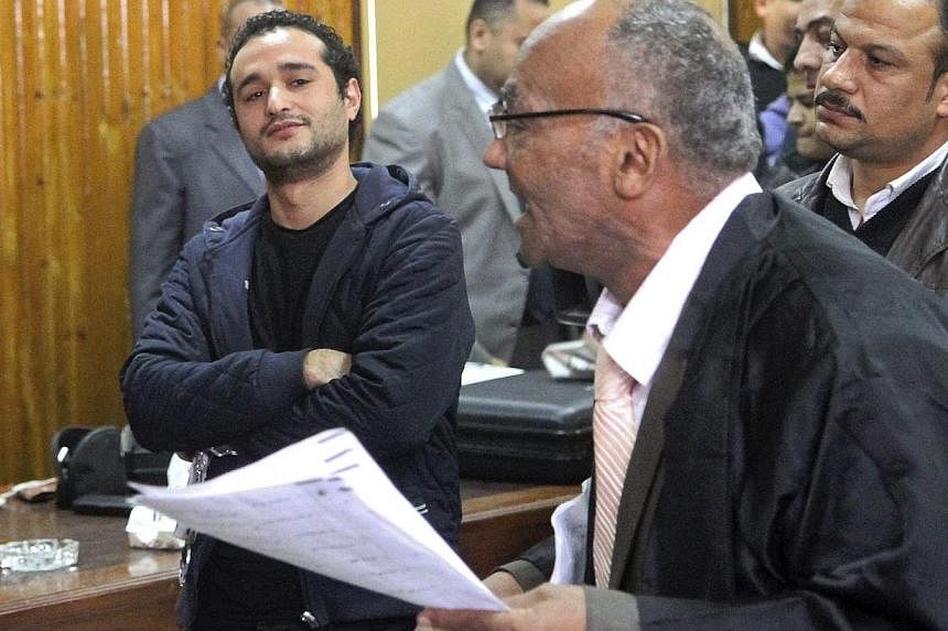 Egyptian political activist Ahmed Douma (left) attends his trial in Cairo, Feb 4, 2015. -- PHOTO: REUTERS