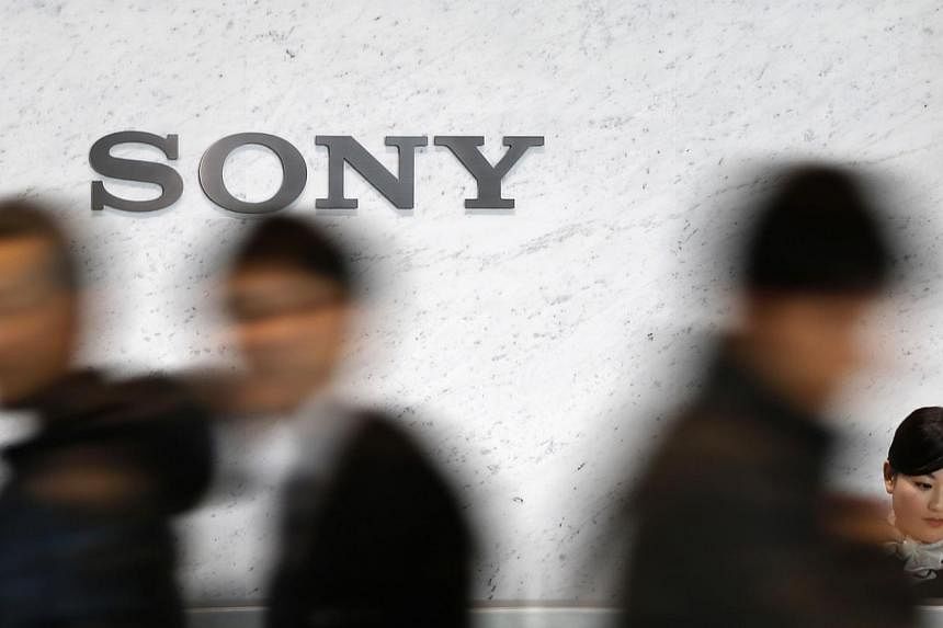 Visitors walking past a Sony logo at the company's headquarters in Tokyo on Feb 4, 2015. -- PHOTO: REUTERS