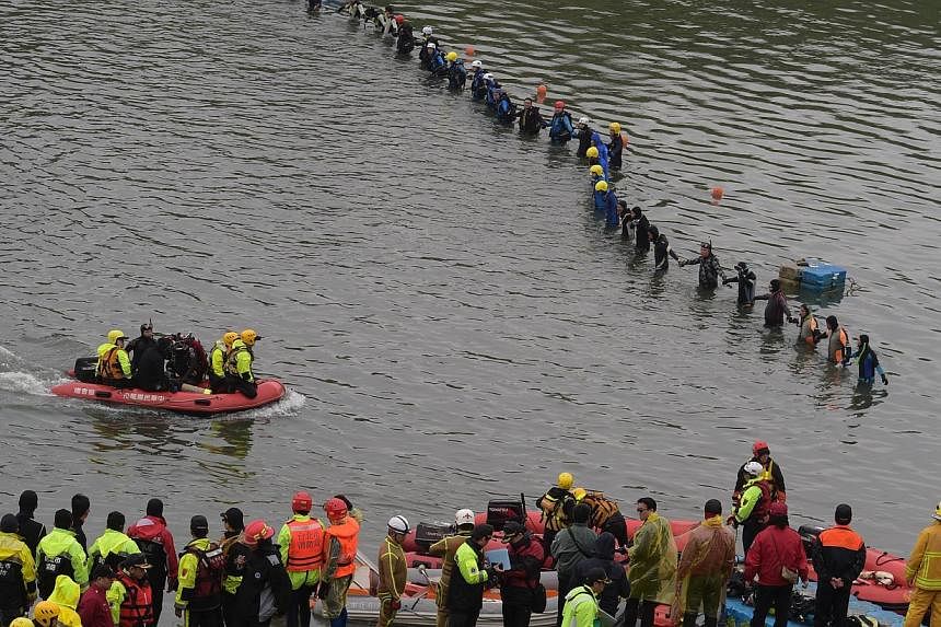 Rescuers and divers search for missing passengers at the crash site of the Transasia ATR 72-600 turboprop plane in the Keelung river in New Taipei City on Feb 6, 2015.&nbsp;The blackbox data and voice recorders of a TransAsia plane that crashed into 