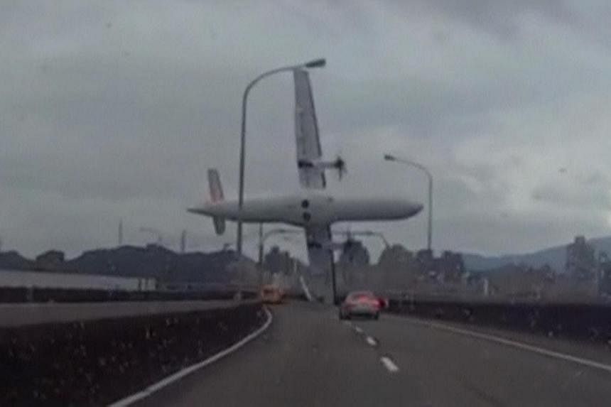 A still image taken from an amateur video shot by a motorist shows a TransAsia Airways plane cartwheeling over a motorway soon after the turboprop ATR 72-600 aircraft took off in New Taipei City on Feb 4, 2015. -- PHOTO: REUTERS