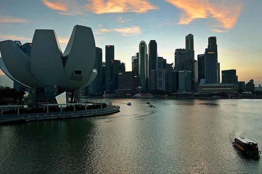 Bumboats travelling on Marina Bay with the skyline of the ArtScience Museum (left) and the Marina Bay financial district as the background.&nbsp;-- PHOTO: ST FILE