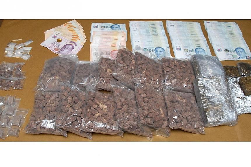 Drugs and cash seized from one of the operations CNB launched to take down the syndicate on Sept 23, 2014. -- PHOTO: CENTRAL NARCOTICS BUREAU