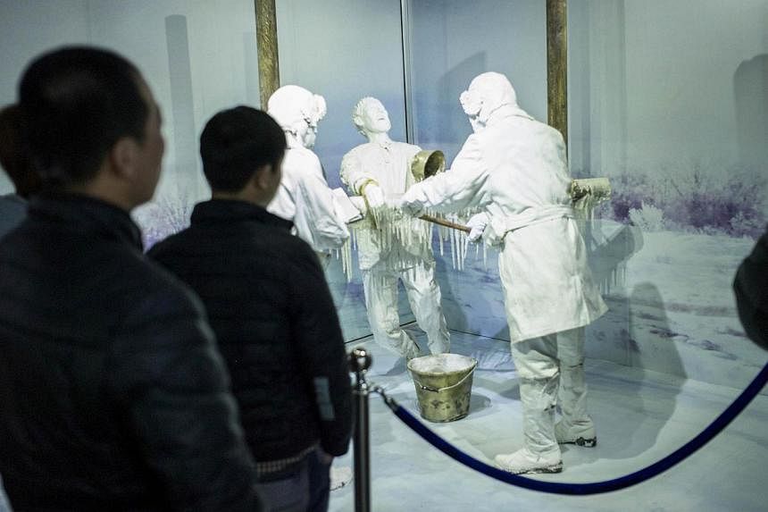 Visitors looking at a scene of human experiments at the Unit 731 museum in Harbin, north-east China's Heilongjiang province, on Jan 7, 2015. -- PHOTO: AFP &nbsp;